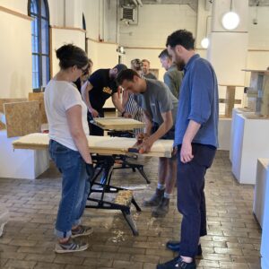 People undergoing retrofit training, in a room with workbenches.